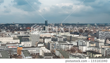 Urban skyline view showcasing modern architecture and cityscape under cloudy sky 133181040