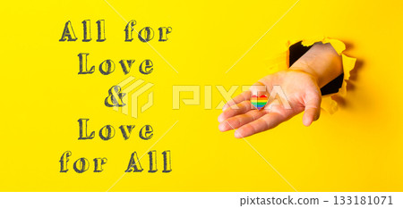Hand holding a rainbow heart with the words All for Love Hand holding a rainbow heart with the words All for Love 133181071