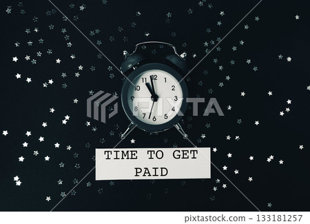 Black and white photo of a clock with the words "Time to get paid" written bel Black and white photo of a clock with the words "Time to get paid" written bel 133181257