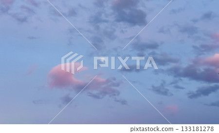 Soft pastel clouds with a bright moon in a serene twilight sky, creating a tranquil atmosphere for relaxation and reflection 133181278