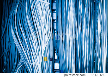 bunch of network cables in wave pattern leading across server ro bunch of network cables in wave pattern leading across server ro 133181690