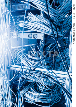 server room rack with tangled network cables creating messy unti 133181691