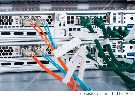Fiber Optic cables connected to optic ports, network cables conn Fiber Optic cables connected to optic ports, network cables conn 133181706