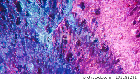 Droplet art. Liquid light. Defocused blue pink neon colorful water texture fluorescent flow pouring on abstract creative background. Droplet art. Liquid light. Defocused blue pink neon colorful water texture fluorescent flow pouring on abstract creative background. 133182281