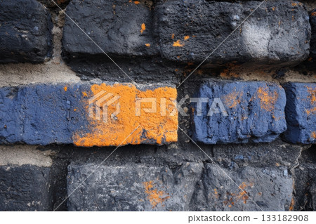 Colorful brick wall with orange and blue paint details Colorful brick wall with orange and blue paint details 133182908