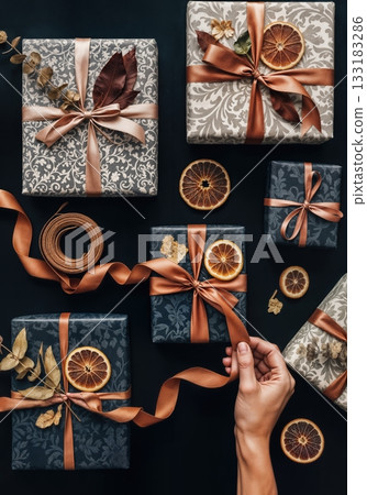 Luxury Gift Wrapping Flat Lay with Artisan Paper Textures, Twine, and Dried Botanicals in Moody Lighting Luxury Gift Wrapping Flat Lay with Artisan Paper Textures, Twine, and Dried Botanicals in Moody Lighting 133183286