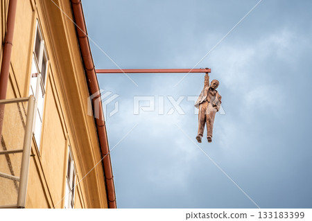 Prague, Czech Republic, August 9, 2023. The Hanging Man is a statue by sculptor David Cerny. It depicts Sigmund Freud hanging from a beam above Husova Street in the Old Town district. Prague, Czech Republic, August 9, 2023. The Hanging Man is a statue by sculptor David Cerny. It depicts Sigmund Freud hanging from a beam above Husova Street in the Old Town district. 133183399