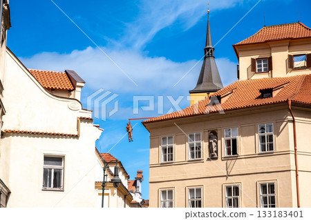 Prague, Czech Republic, August 9, 2023. The Hanging Man is a statue by sculptor David Cerny. It depicts Sigmund Freud hanging from a beam above Husova Street in the Old Town district. Prague, Czech Republic, August 9, 2023. The Hanging Man is a statue by sculptor David Cerny. It depicts Sigmund Freud hanging from a beam above Husova Street in the Old Town district. 133183401