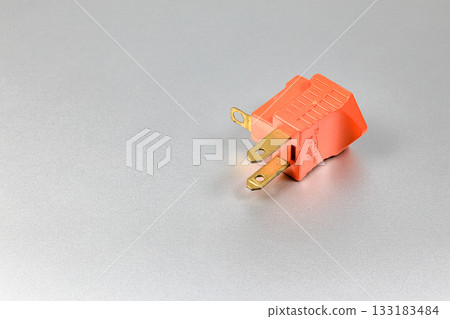 Orange plugs adapters for NEMA plug type B convert to type A with grounded contact isolated on white background. Orange plugs adapters for NEMA plug type B convert to type A with grounded contact isolated on white background. 133183484