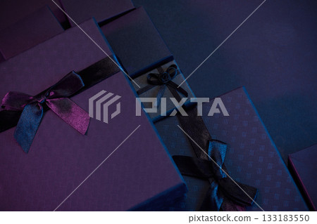 Elegant Gift Boxes. Stylish gift boxes in deep purple and blue tones with satin ribbons 133183550