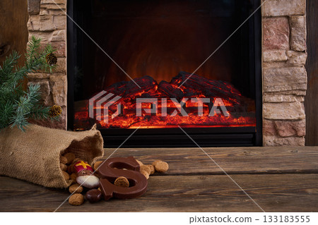 Saint Nicholas - Sinterklaas sweets near the fireplace Saint Nicholas - Sinterklaas sweets near the fireplace 133183555