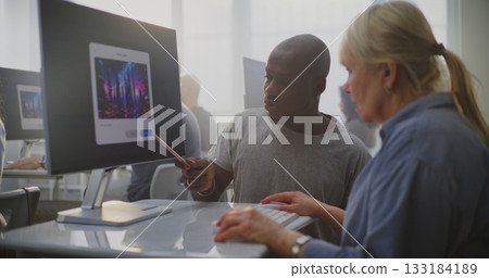 Teacher Enthusiastically Helps Mature Student Craft AI Prompts on Computer Teacher Enthusiastically Helps Mature Student Craft AI Prompts on Computer 133184189
