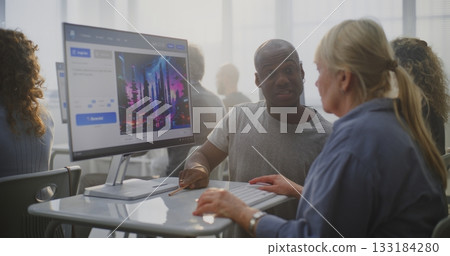 Teacher Enthusiastically Helps Mature Student Craft AI Prompts on Computer 133184280