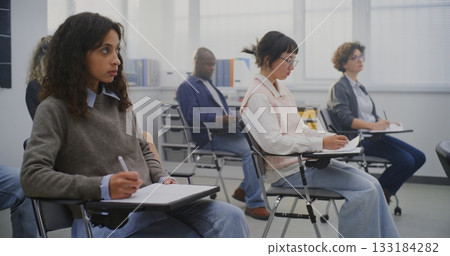 Diverse Adult Learners Concentrated on Writing Task During Lesson in Classroom 133184282