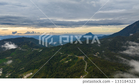 Aerial view of mountains with rainforest and jungle during sunset. Borneo,Sabah, Malaysia. Aerial view of mountains with rainforest and jungle during sunset. Borneo,Sabah, Malaysia. 133184323