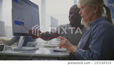 Young Instructor Explains AI Image Generation Process Senior Female Student During Creative Tech Lesson 133184324