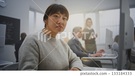 Smiling Woman in Modern Computer Classroom Focuses on Coding Project 133184333