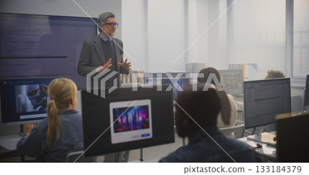Stylish Male Instructor Explaining AI Generation Principles to Adult Students 133184379