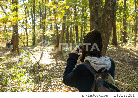 Autumn in Akagi Nature Park: A woman looking through binoculars Autumn in Akagi Nature Park: A woman looking through binoculars 133185291