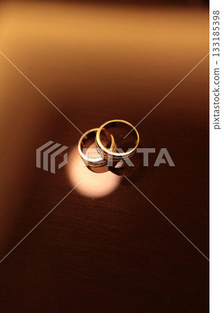 Elegant precious Diamond wedding Rings Resting On Surface With Blurred Backdrop For Wedding ceremony Elegant precious Diamond wedding Rings Resting On Surface With Blurred Backdrop For Wedding ceremony 133185398