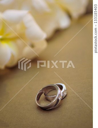 Elegant precious Diamond wedding Rings Resting On Surface With Blurred Backdrop For Wedding ceremony Elegant precious Diamond wedding Rings Resting On Surface With Blurred Backdrop For Wedding ceremony 133185403