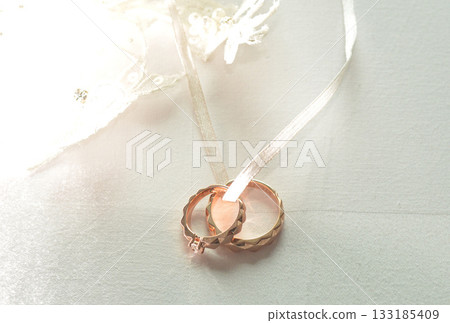 Elegant precious Diamond wedding Rings Resting On Surface With Blurred Backdrop For Wedding ceremony Elegant precious Diamond wedding Rings Resting On Surface With Blurred Backdrop For Wedding ceremony 133185409