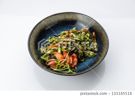 Warm grilled vegetable salad with pesto and balsamic in black bowl, top view Warm grilled vegetable salad with pesto and balsamic in black bowl, top view 133185518