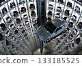 Automated car storage tower with robotic delivery system. Automated car storage tower features multiple floors of compactly parked vehicles, arranged around a central vertical axis. 133185525