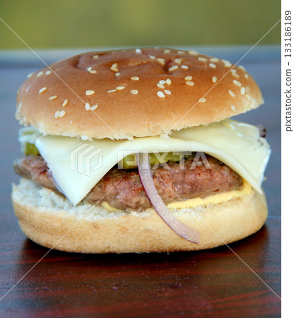 Cooking burger outdoors. Outdoor food. Fresh hamburger. Fresh cheeseburger Cooking burger outdoors. Outdoor food. Fresh hamburger. Fresh cheeseburger 133186189