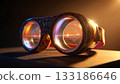 Ornate goggles of discovery. Ornate steampunk-style goggles resting on a surface, illuminated dramatically from the side.  133186646