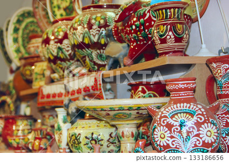 Earthenware on shelves of shop. Ceramic goods. Products of ceramics on sale Earthenware on shelves of shop. Ceramic goods. Products of ceramics on sale 133186656