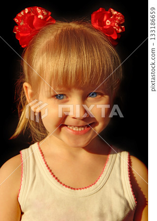 Portrait of smiling baby in amusing red bows 133186659