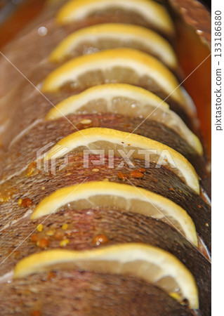 Rainbow trout fish on ready for cooking with lemon. Tasty fish dish Rainbow trout fish on ready for cooking with lemon. Tasty fish dish 133186880
