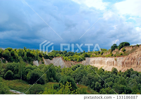 Cretaceous quarry. Landscape with sandy cliffs and thunder storm sky Cretaceous quarry. Landscape with sandy cliffs and thunder storm sky 133186887