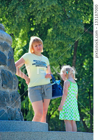 Mom scolding daughter for naughty behavior outside Mom scolding daughter for naughty behavior outside 133187000