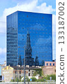 Tall skyscraper with church reflection in windows in Lodz. 133187002