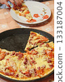 Slices of fresh appetizing pizza with delicious ingredients on plate 133187004