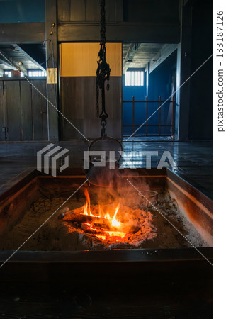 Iron bottle in the hearth 133187126