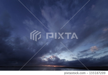 Dynamic evening sky with a variety of clouds and the harbor. Ultra-wide angle. Sky-focused. 240218pm 133187209
