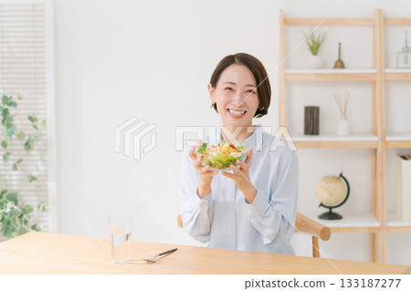 Young woman eating in the dining room Young woman eating in the dining room 133187277