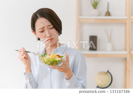 A woman who does not like vegetables A woman who does not like vegetables 133187386