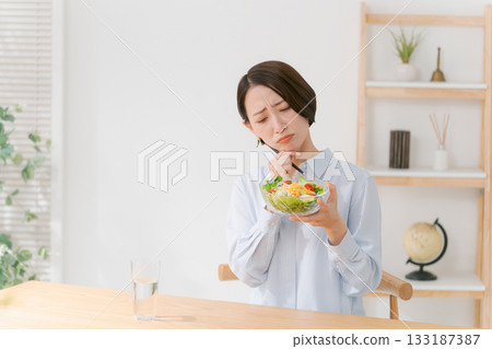 A woman who does not like vegetables A woman who does not like vegetables 133187387