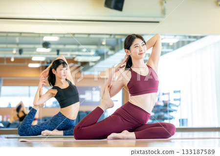 Woman doing yoga at the gym Woman doing yoga at the gym 133187589
