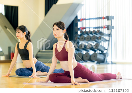 Young woman doing yoga in yoga studio Young woman doing yoga in yoga studio 133187593