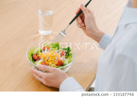 Women's hand with salad Women's hand with salad 133187748