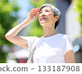 Beware of heatstroke! Elderly woman exposed to strong summer sunlight 133187908