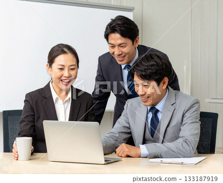 A business team looking at a computer A business team looking at a computer 133187919