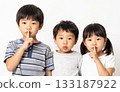 Children posing secretly with their index fingers on their lips 133187922