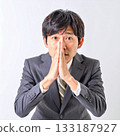 Businessman in a request pose with palms together 133187927