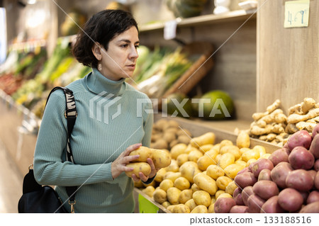 woman chooses potatoes woman chooses potatoes 133188516